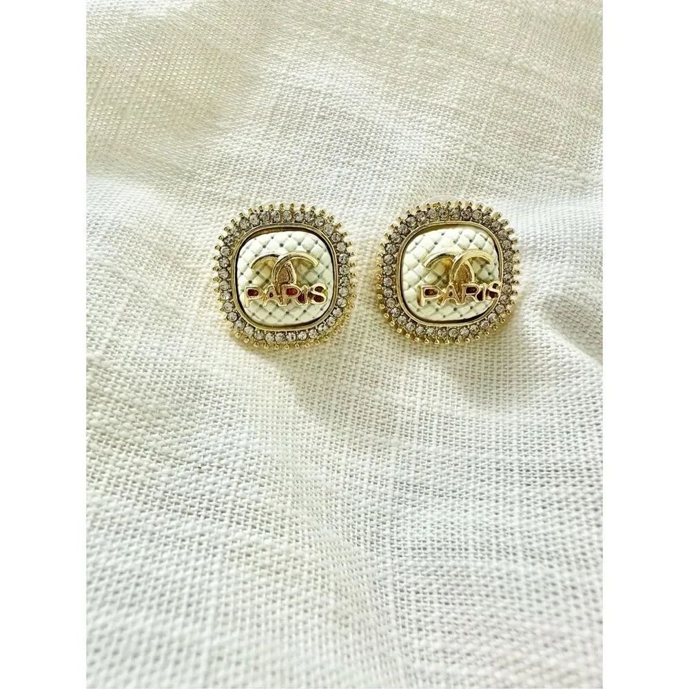 Cream and rhinestone logo studs ￼